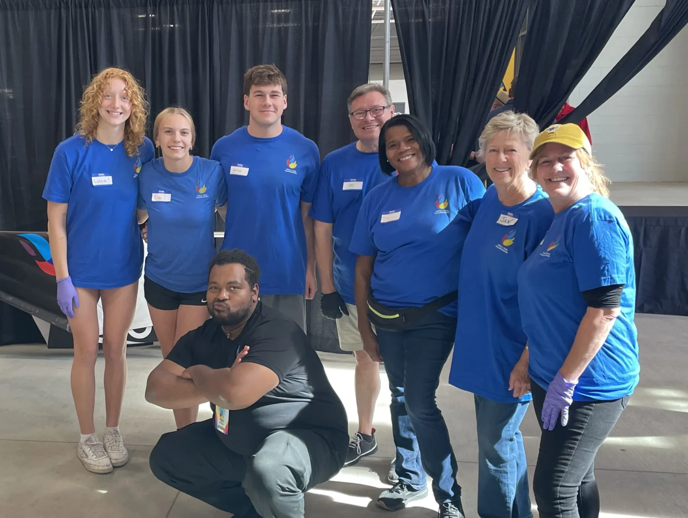 WFC competitor Bryan Morales with the event staff in the backstage area of the competition.