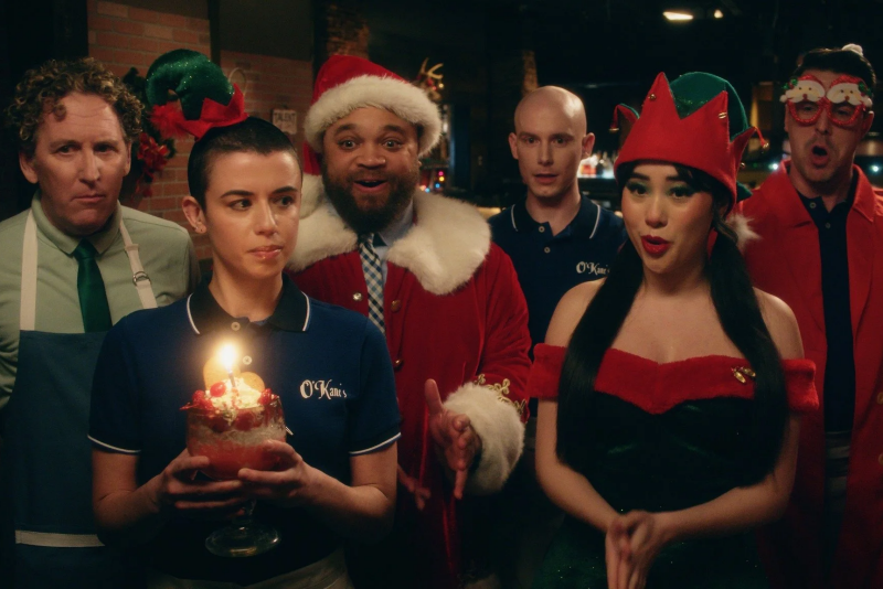 Holiday restaurant scene with the ensemble cast of We’re So Dead