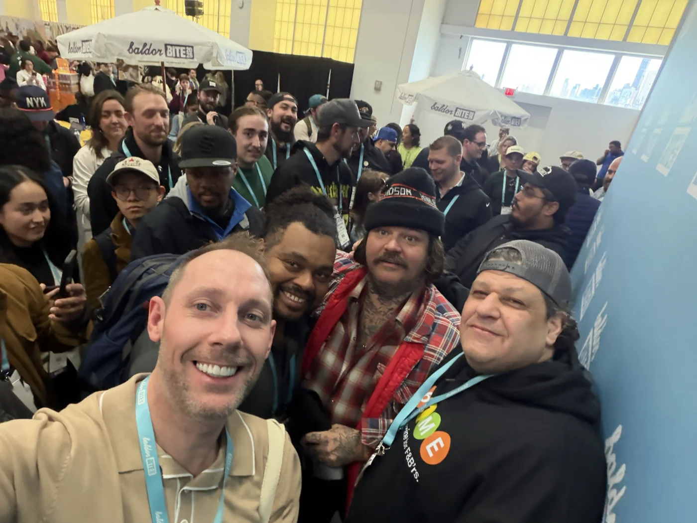 Matty Matheson standing with the 86'd Me crew and fans in a crowded hall at Baldor BITE 2026
