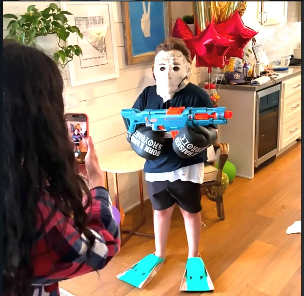 Matty Matheson's son wearing an authentic Michael Myers mask from the Halloween movie set, signed by the cast and crew, gifted by Jamie Lee Curtis.
