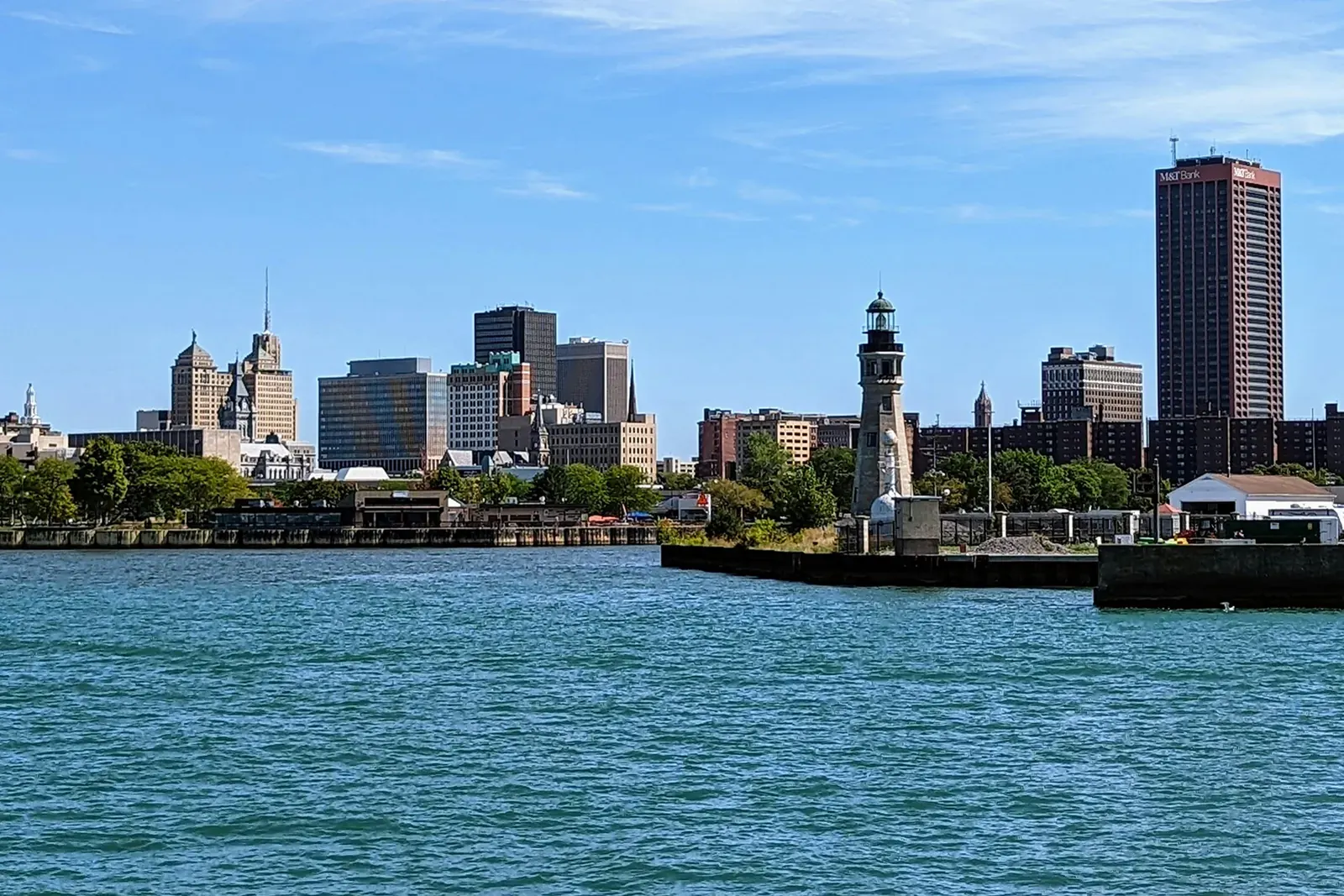 Buffalo skyline and the Buffalo Main Lighthouse across the water on a sunny day