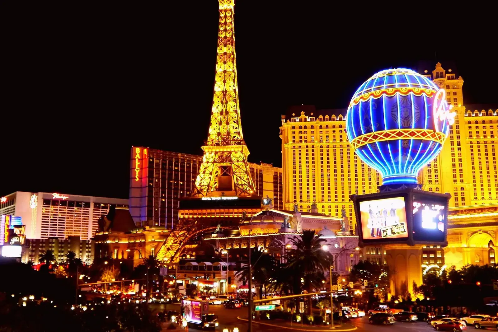 The Paris Las Vegas Eiffel Tower and balloon sign lit up on the Strip at night