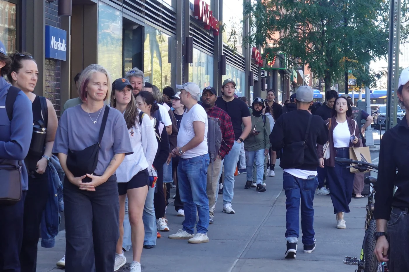 Crowd waiting in the famous queue outside Katz's Deli on the Lower East Side in New York City.